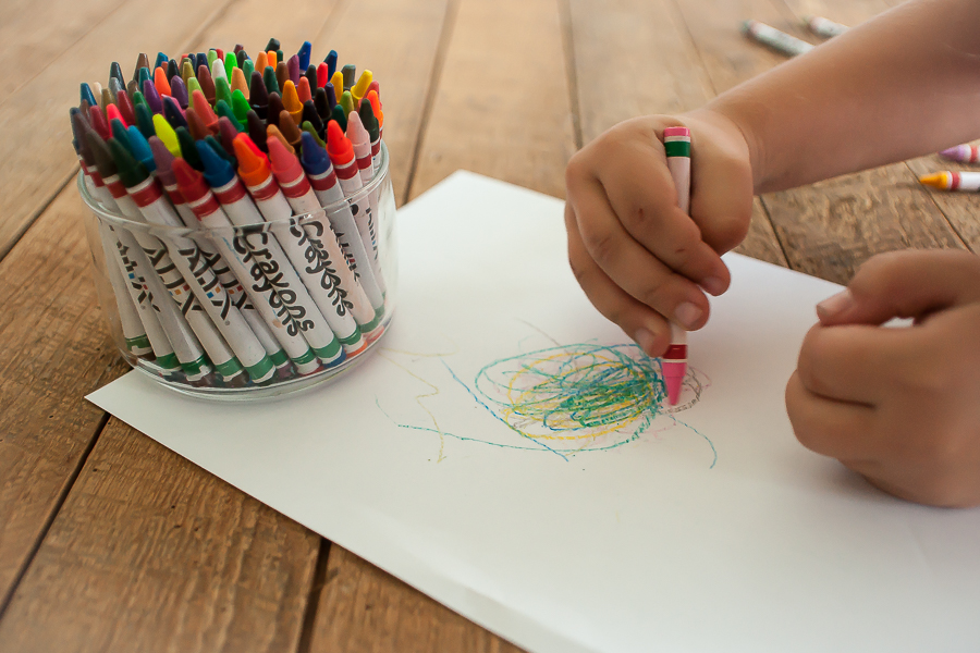 Child Coloring With Crayons